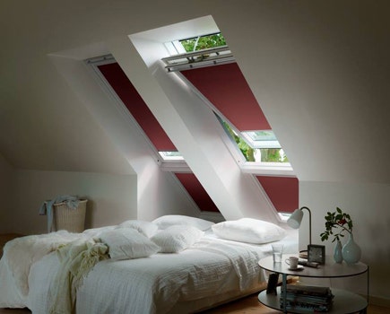 VELUX pitched roof windows with red blinds for loft conversions